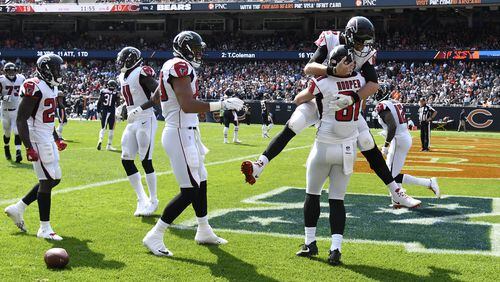 CHICAGO, IL - SEPTEMBER 10: Quarterback Matt Ryan #2 of the Atlanta Falcons celebrates with Austin Hooper #81 after Hooper scored a touchdown in the fourth quarter against the Chicago Bears at Soldier Field on September 10, 2017 in Chicago, Illinois. (Photo by David Banks/Getty Images)
