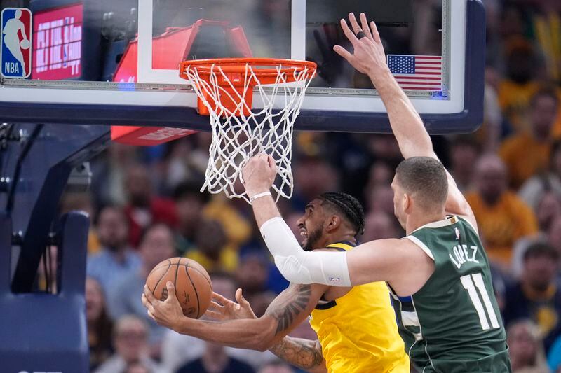 Indiana Pacers' Obi Toppin puts up a shot against Milwaukee Bucks' Brook Lopez (11) during the first half of Game 4 of the first round NBA playoff basketball series, Sunday, April 28, 2024, in Indianapolis. (AP Photo/Michael Conroy)