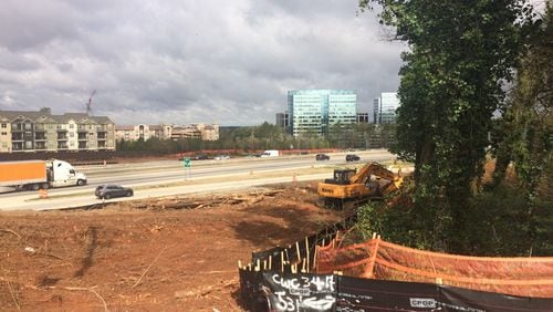 Trees are being removed from the side of Ga. 400 as part of a four-year, $800 million reconstruction of the interchange with I-285 in the Sandy Springs-Dunwoody area. BECCA GODWIN