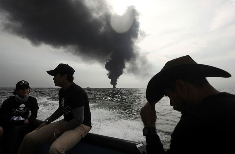 FILE - Members of the marine wildlife conservation organization Sea Shepherd monitor the fuel tanker Burgos, as it continues to burn a day after it erupted in flames off the coast of the port city of Boca del Rio, Mexico, Sept. 25, 2016. Mexico is committed to having 43% of the energy it generates come from non-contaminating sources by 2030. (AP Photo/Felix Marquez, File)