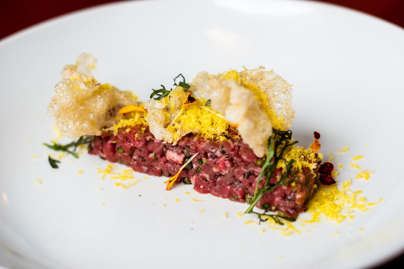 The beef tartare at Tiny Lou’s is bold and clean in flavor, with crunchy puffs of fried beef tendon. CONTRIBUTED BY HENRI HOLLIS