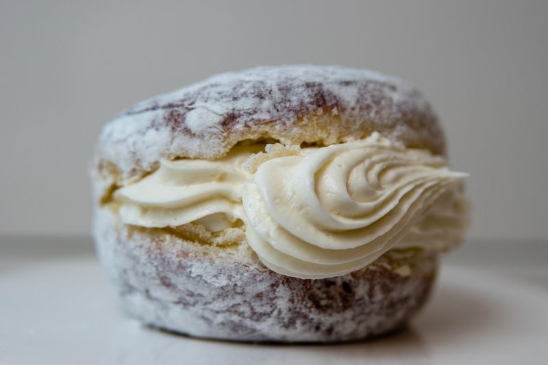 The Sweet Jane doughnut at Doughnut Dollies is messy, but worth it — a plain doughnut is overfilled with sweet cream and covered in powdered sugar. CONTRIBUTED BY HENRI HOLLIS