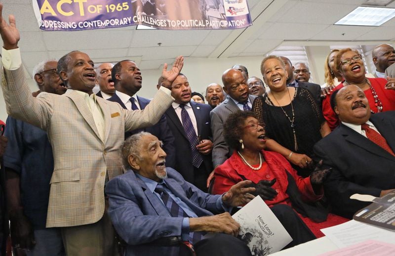 August 2015: At the 50th Observance of the Struggle for the 1965 Voting Rights Act, Dr. Joseph Lowery (seated, left) delivered closing remarks, and then everyone joined in song. DeKalb CEO Michael Thurmond (left) and next to him, Mayor Kasim Reed, took part. BOB ANDRES / BANDRES@AJC.COM