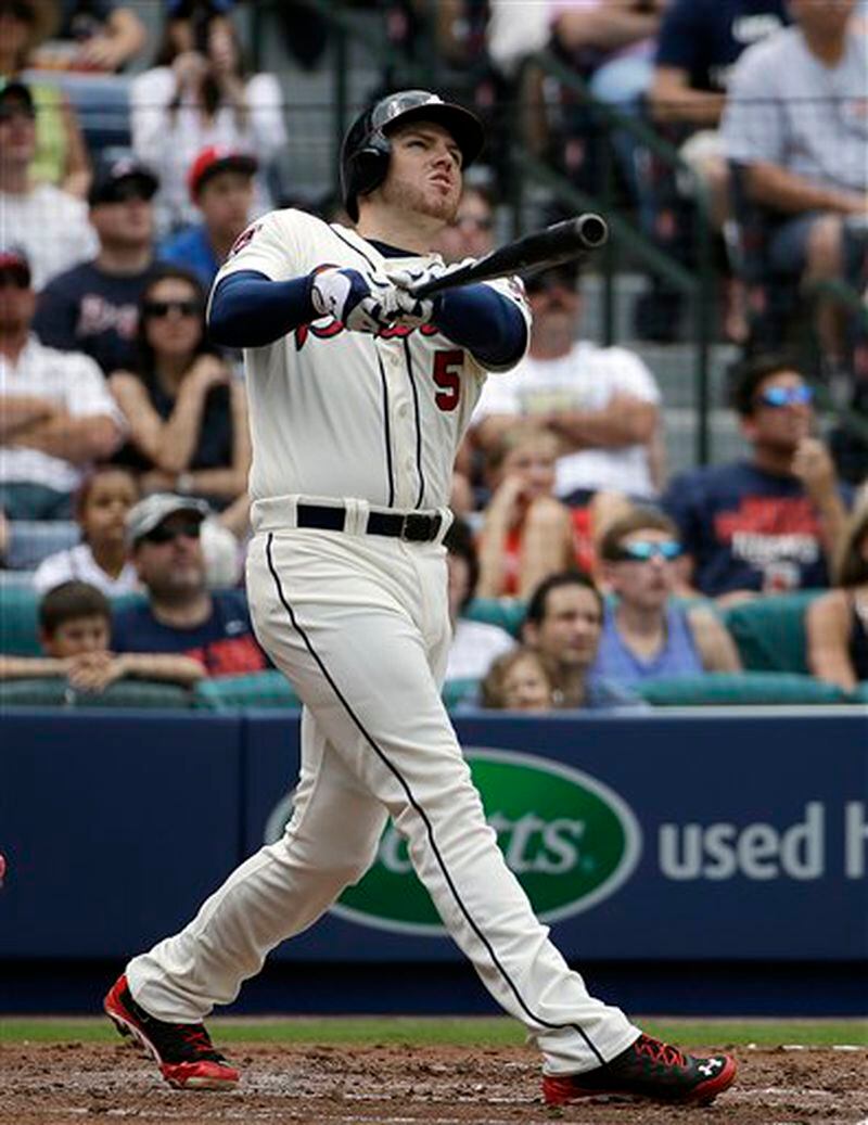 Atlanta Braves' Freddie Freeman hits a two-run home run to score teammate Jason Heyward in the second inning of a baseball game against the Washington Nationals, Sunday, April 13, 2014, in Atlanta. (AP Photo/David Goldman) Freddie Freeman follows through on one of the nine home runs he's hit against the Nationals.