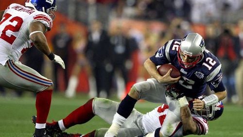 Patriots quarterback Tom Brady is sacked by Giants' defensive end Michael Strahan in the third quarter during Super Bowl XLII between the New York Giants and the New England Patriots at the University of Phoenix Stadium in Glendale, Arizona, on February 3, 2008. Donald Miralle: Getty Images
