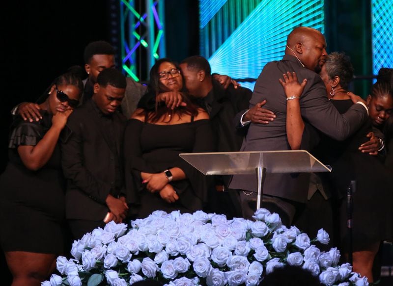 Rev. Markel Hutchins, right, hugs the parents of Alexis Crawford while her siblings hug each other during a funeral service in Athens for Alexis Janae Crawford, a slain 21-year-old senior attending Clark Atlanta University.