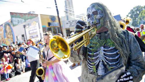 Christopher Manson (right) plays the trumpet as he marches in the 14th annual Little 5 Points Halloween Parade in Atlanta in 2014. Thousands of people lined the streets to watch the parade which featured local haunted attractions, bands and floats.