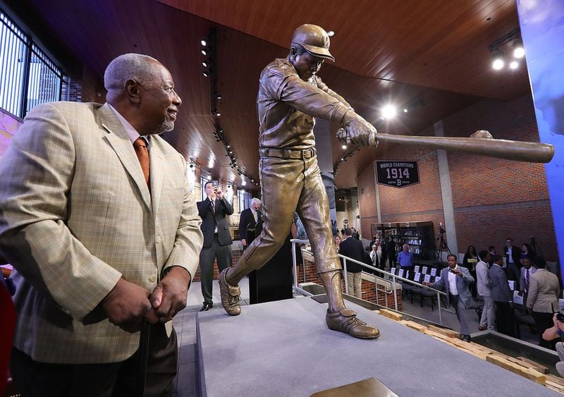Hank Aaron takes in his new statue in Monument Garden at SunTrust Park after the unveiling ceremony Wednesday night. (Curtis Compton/ccompton@ajc.com)