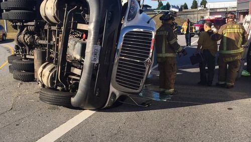 A tractor-trailer overturned Friday on I-75 southbound. (Credit: Atlanta Fire Rescue)