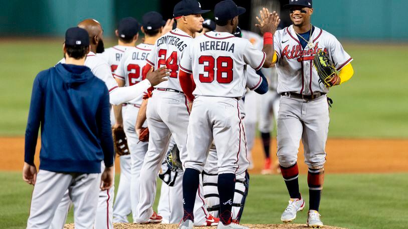 Ronald Acuña celebrates with teammates after Tuesday's victory over the Washington Nationals, the 13th straight win for the Braves. The team's win streak is now 14 as it prepares for Friday's game in Chicago against the Cubs. (AP Photo/Julia Nikhinson)