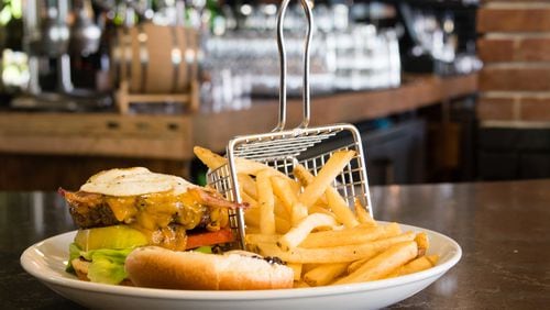 Todd English Tavern serves the Southern Burger, a half-pound beef patty with lettuce, tomato, onion a fried egg, spicy mayo and wild berry jam. CONTRIBUTED BY HENRI HOLLIS