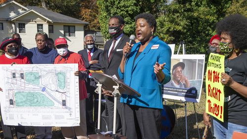 Councilman Andre Dickens (center) listens as City Council President Felicia Moore speaks during an rally in support of Peoplestown residents who are locked in a legal battle with the city of Atlanta's over their attempts to stay in their homes. PHIL SKINNER FOR THE ATANTA JOURNAL-CONSTITUTION