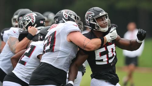 Falcons offensive lineman Jason Spriggs (left) and outside linebacker George Obinna go at it on the line of scrimmage during the first day in pads at training camp Tuesday, Aug. 3, 2021, in Flowery Branch. (Curtis Compton / Curtis.Compton@ajc.com)