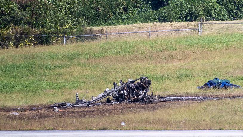 Emergency response teams works the scene of a plane crash at Peachtree DeKalb Airport on Friday, October 8, 2021. Two adults and two children were killed in the crash. (Alyssa Pointer/ Alyssa.Pointer@ajc.com)