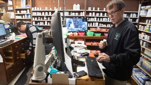 Owner Derek Chapman works on a customers' order at his Hapeville pharmacy, Chapman Drug, Thursday, February 3, 2022.     STEVE SCHAEFER FOR THE ATLANTA JOURNAL-CONSTITUTION