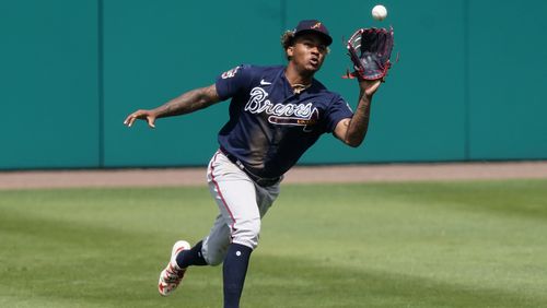 Braves center fielder Cristian Pache makes a running catch on a fly ball by Minnesota Twins' Josh Donaldson in the fifth inning of a spring training baseball game against the Atlanta Braves Monday, March 22, 2021, in Fort Myers, Fla.