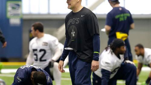 Seattle Seahawks defensive coordinator Dan Quinn, center, walks on the field as players stretch Friday, Jan. 23, 2015, during NFL football practice in Renton, Wash. The Seahawks are to face the New England Patriots in Super Bowl XLIX on Sunday, Feb. 1, 2015, in Glendale, Ariz. (AP Photo/Ted S. Warren) Seattle defensive coordinator Dan Quinn is expected to be named Falcons head coach after the Super Bowl. (AP photo)