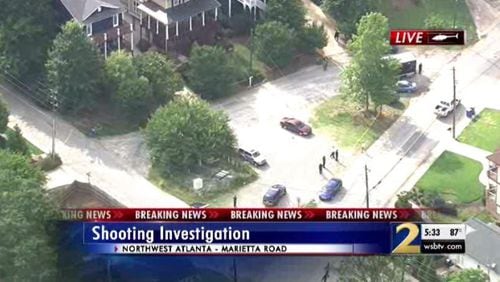 Police have arrested a man who they say shot another man in the head  outside an Atlanta home.
