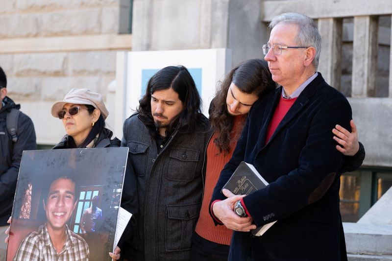 Manuel Teran's mother Belkis Teran, from left, brother Daniel Paez, brother Pedro Santema and father Joel Paez listen to their attorney speak during a press conference on March 13. (Ben Gray for the Atlanta Journal-Constitution)