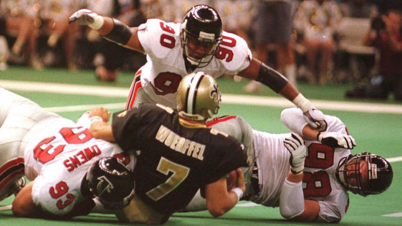Atlanta defensive end Chuck Smith (90) assists teammates Dan Owens (93) and Travis Hall (98) in bringing down Saints quarterback Danny Wuerffel during the Falcons 23-17 win at the Louisiana Superdome in New Orleans Sunday Oct. 12, 1997.