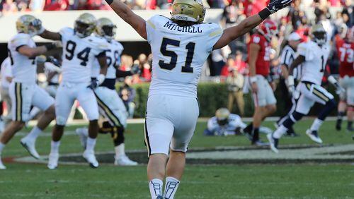 November 26, 2016, Athens: Georgia quarterback Jacob Eason walks off the field as Georgia Tech linebacker Brant Mitchell intercepts his pass and starts the celebration on the final play of the game for a 28-27 victory over Georgia in a NCAA college football rivalry game on Saturday, Nov. 26, 2016, in Athens. Curtis Compton/ccompton@ajc.com