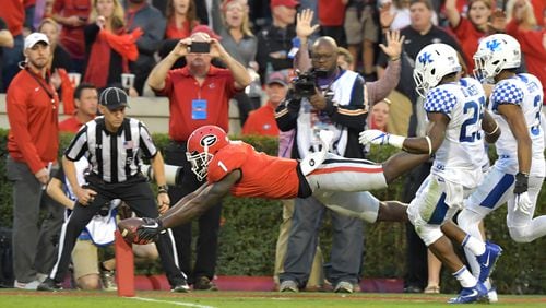 Georgia running back Sony Michel (1) dives into the endzone for a touchdown during Saturday's game against Kentucky. Hyosub Shin/hshin@ajc.com