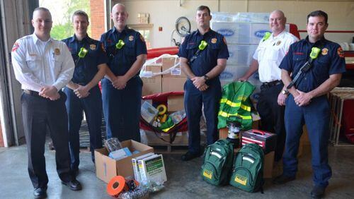 Members of the Milton Fire-Rescue Department show disaster assistance supplies funded by a recent grant to the city’s Community Emergency Response Team (CERT) program. CITY OF MILTON