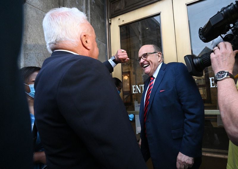 August 17, 2022 Atlanta - Rudy Giuliani smiles as he arrives with his attorney Robert J. Costello (left) to testify for the special grand jury at Fulton County Courthouse in Atlanta on Wednesday, August 17, 2022. Rudy Giuliani, the onetime personal attorney of former President Donald Trump, entered the Fulton County courthouse on Wednesday morning to testify before the special purpose grand jury examining Georgia’s 2020 elections. (Hyosub Shin / Hyosub.Shin@ajc.com)