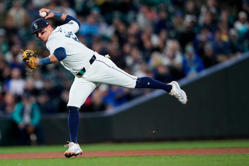 Seattle Mariners third baseman Luis Urías throws to first base for an out against Atlanta Braves' Jarred Kelenic during the third inning of a baseball game Monday, April 29, 2024, in Seattle. (AP Photo/Lindsey Wasson)