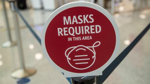A sign requiring customers to wear masks is displayed at the Delta Air Lines ticket counter line at Hartsfield-Jackson Atlanta International Airport, Friday, Sept. 4, 2020. (Alyssa Pointer / Alyssa.Pointer@ajc.com)