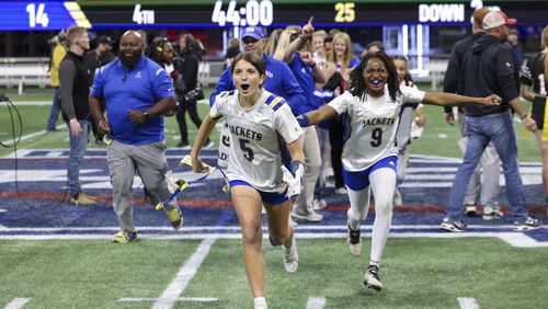 Southeast Bulloch players from left; Natalya Odom (9) and Korine Talkington (5) run to their fans as they celebrates their 14-0 win against North Oconee during the Girl’s Flag Football A-4A GHSA State Championship game at Mercedes-Benz Stadium, Monday, December. 11, 2023, in Atlanta. (Jason Getz / Jason.Getz@ajc.com)