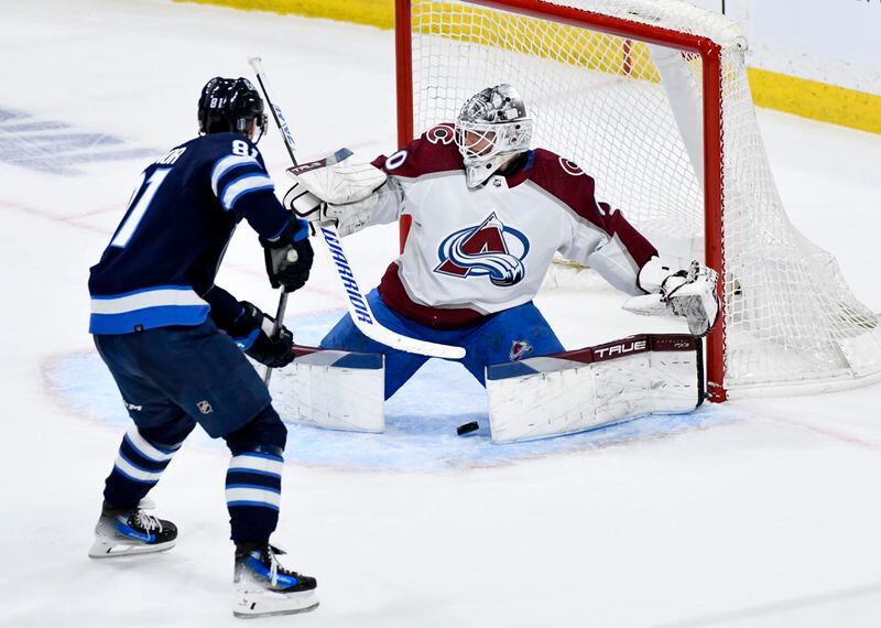 Colorado Avalanche goaltender Alexandar Georgiev (40) makes a save as Winnipeg Jets' Kyle Connor (81) looks for the rebound during the second period in Game 5 of an NHL hockey Stanley Cup first-round playoff series in Winnipeg, Manitoba, Tuesday, April 30, 2024. (Fred Greenslade/The Canadian Press via AP)