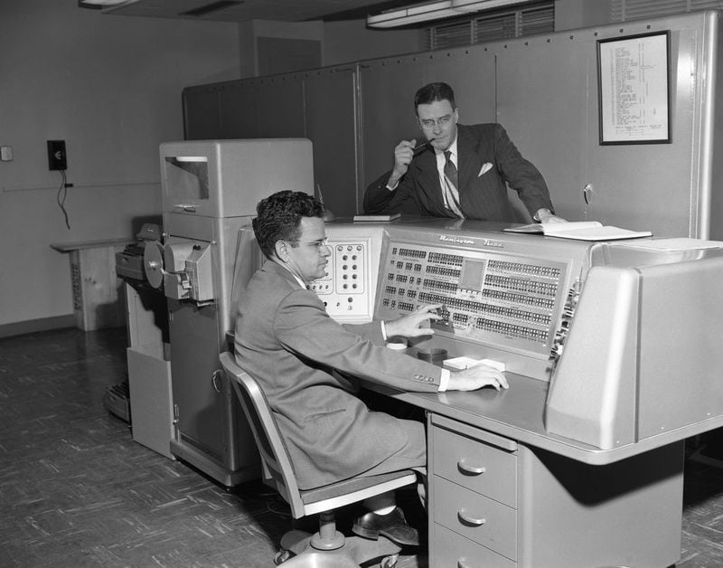 Programmer Woodrow W. Jackson, seated, and Dr. E. K. Ritter director of the Rich Electronic Computer Center at Georgia Tech on Oct. 24, 1955. The piece by Floyd E. Jillson was titled “The Electric Brain.”