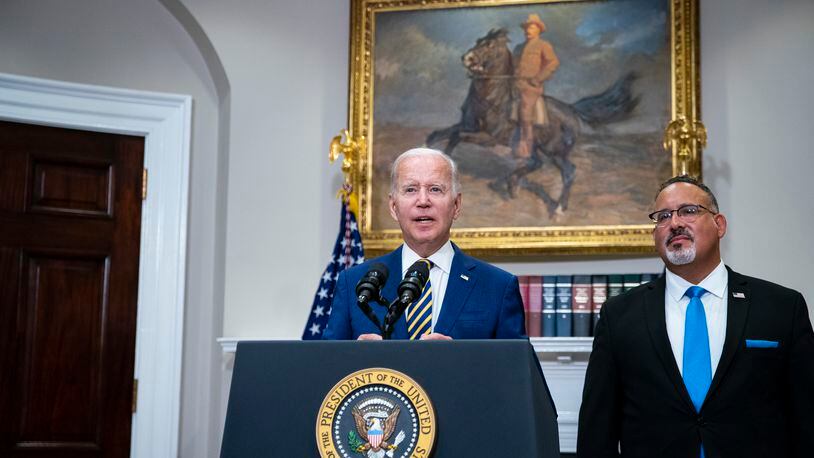 President Joe Biden speaks about student loan forgiveness, while joined by Education Secretary Miguel Cardona, in the Roosevelt Room of the White House, Washington, on  Aug. 24, 2022. (Al Drago/The New York Times)