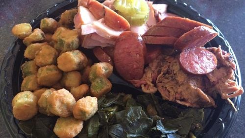 A three-meat plate at Sam’s BBQ-1 in east Cobb is loaded with pulled pork, smoked sausage and turkey, with sides of fried okra and collards. CONTRIBUTED BY WENDELL BROCK