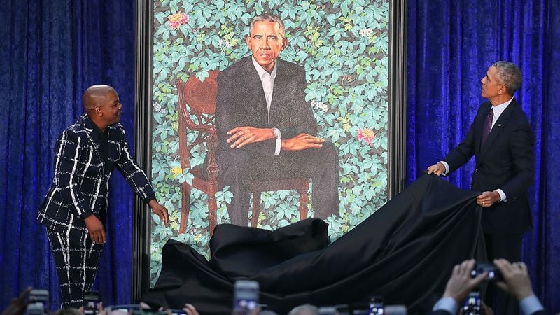 WASHINGTON, DC - FEBRUARY 12:  Former U.S. President Barack Obama (R) and artist Kehinde Wiley unveil his portrait during a ceremony at the Smithsonian's National Portrait Gallery, on February 12, 2018 in Washington, DC. The portraits were commissioned by the Gallery, for Kehinde Wiley to create President Obama's portrait, and Amy Sherald that of Michelle Obama.  (Photo by Mark Wilson/Getty Images)