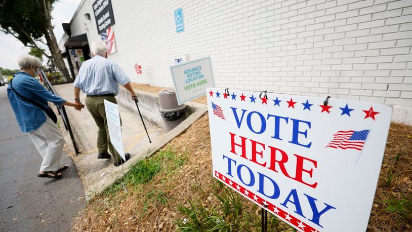 People walk through the ramp at the Voter Registration & Elections in Dekalb during the first day of early voting on Monday, June 13, 2022. Votes are underway in metro Atlanta for runoff races. Miguel Martinez / miguel.martinezjimenez@ajc.com