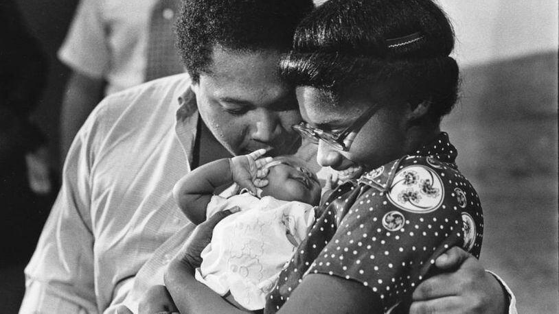 Bobby and Sandra Alexander had a kiss for their returned baby Shanta at a Grady Hospital press conference on Sept. 16, 1981. “Things turned out pretty well,” the mother said recently. “After everything we went through together, I can’t imagine being without her. She’s still my baby. I didn’t want to think about life without her.” (Lanna Swindler / AJC Archive at GSU Library AJCP339-175d)