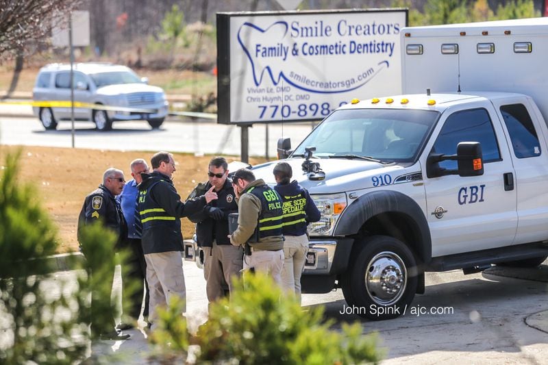 GBI and Henry County police investigators were on the scene of an officer-involved shooting at a dentist's office on Jonesboro Road. JOHN SPINK / JSPINK@AJC.COM