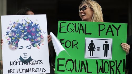 Elana Goodman joins with other protesters calling for women to be paid equally to their male co-workers on March 14, 2017 in Fort Lauderdale, Fla. A report released Wednesday found many women professors are paid less than their male counterparts.