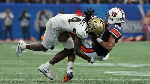 January 1, 2018 - Atlanta, Ga: UCF Knights defensive back Nevelle Clarke (14) tackles Auburn Tigers wide receiver Ryan Davis (23) after a catch by Davis during the second quarter of the Chick-fil-A Peach Bowl at Mercedes-Benz Stadium Monday, January 1, 2018, in Atlanta. PHOTO / JASON GETZ