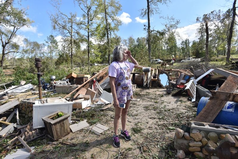 Sharon Granade stands on destroyed two-car garage after Tropical Storm Michael  passed on Flint River Estates Road in Roberta on Thursday, October 11, 2018. Tropical Storm Michael swept out of Georgia before sunrise, leaving a trail of destruction in its wake. HYOSUB SHIN / HSHIN@AJC.COM
