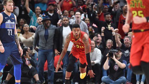 Hawks guard Kent Bazemore (24) celebrates after he scored during the second half of the home opener in an NBA basketball game at State Farm Arena on Wednesday, October 24, 2018. HYOSUB SHIN / HSHIN@AJC.COM