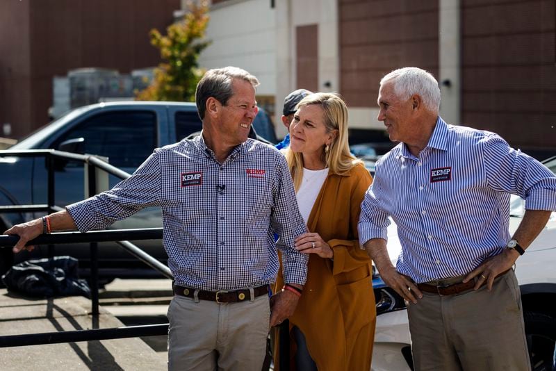 From left, Gov. Brian Kemp, the Republican incumbent; his wife Marty Kemp; and former Vice President Mike Pence chat before taking the stage at a reelection campaign rally for Kemp in Cumming, Ga., on Tuesday, Nov. 1, 2022. Kemp praised Kemp over the weekend after Pence dropped out of the race for the Republican presidential nomination. (Audra Melton/The New York Times)