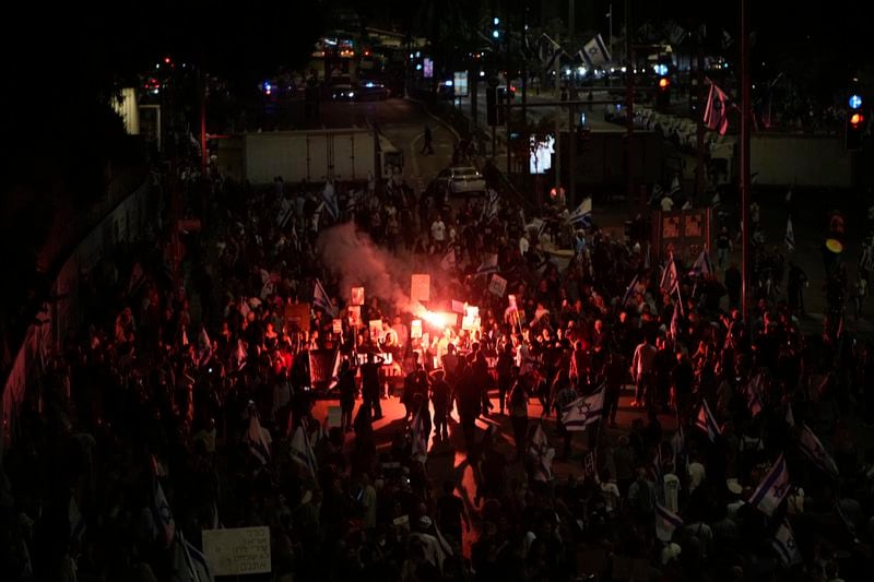 People protest against Israeli Prime Minister Benjamin Netanyahu's government and call for the release of hostages held in the Gaza Strip by the Hamas militant group in Tel Aviv, Israel, Saturday, April 27, 2024. (AP Photo/Ohad Zwigenberg)