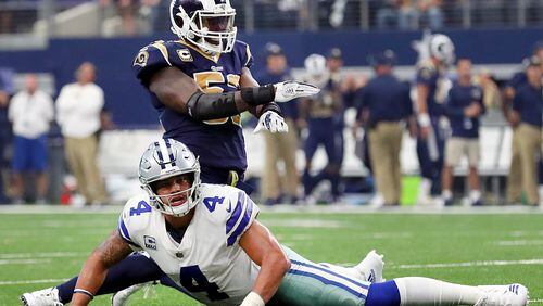 Cowboys quarterback Dak Prescott looks on as Alec Ogletree of the Rams celebrates after Dallas failed to score on a two-point conversion in the fourth quarter Sunday at AT&T Stadium.