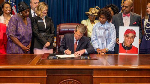 Gov. Brian Kemp, pictured here signing a bill into law earlier, on Friday vetoed a bill DeKalb County Schools wanted that would have addressed some effects of future annexations on the school district.