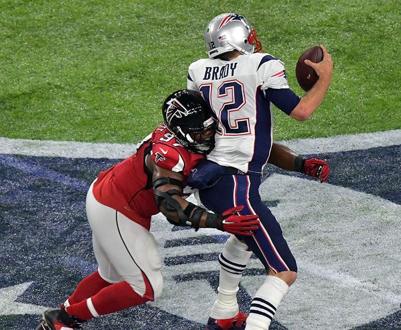 Patriots quarterback Tom Brady (12) is sacked by Falcons defensive tackle Grady Jarrett (97) in Super Bowl LI Feb. 5, 2017, at NRG Stadium in Houston.