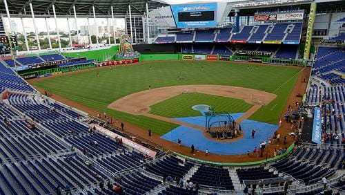 In this May 14, 2013, file photo, the Cincinnati Reds take batting practice at Marlins Park before a baseball game against the Miami Marlins in Miami. A person familiar with the decision says the Marlins have been awarded the 2017 All-Star Game, and an announcement by baseball Commissioner Rob Manfred is planned for this week at the team’s ballpark. (AP Photo/Lynne Sladky, File)