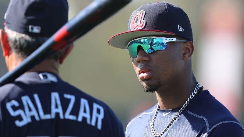 Braves outfield prospect Ronald Acuna gets some pointers from coach Luis Salazar on Friday, Feb 16, 2018.